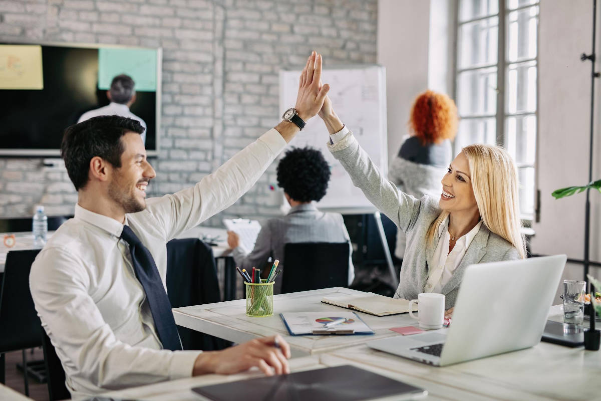 happy-business-people-supporting-each-other-giving-high-five-office_1200